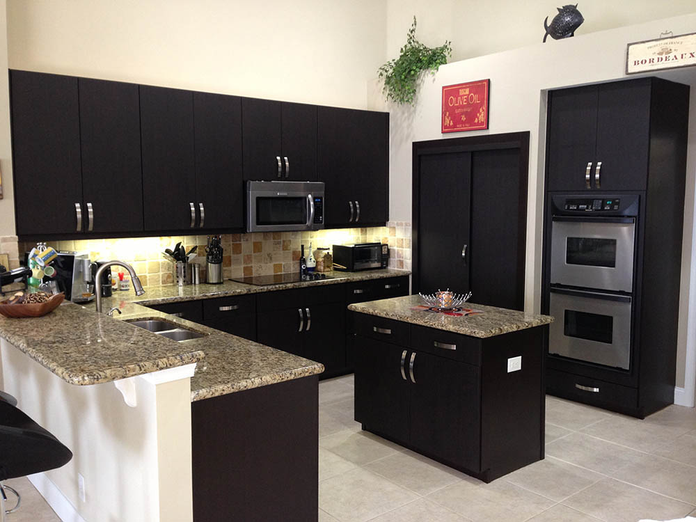 Dark espresso kitchen remodel with granite countertops and stainless appliances